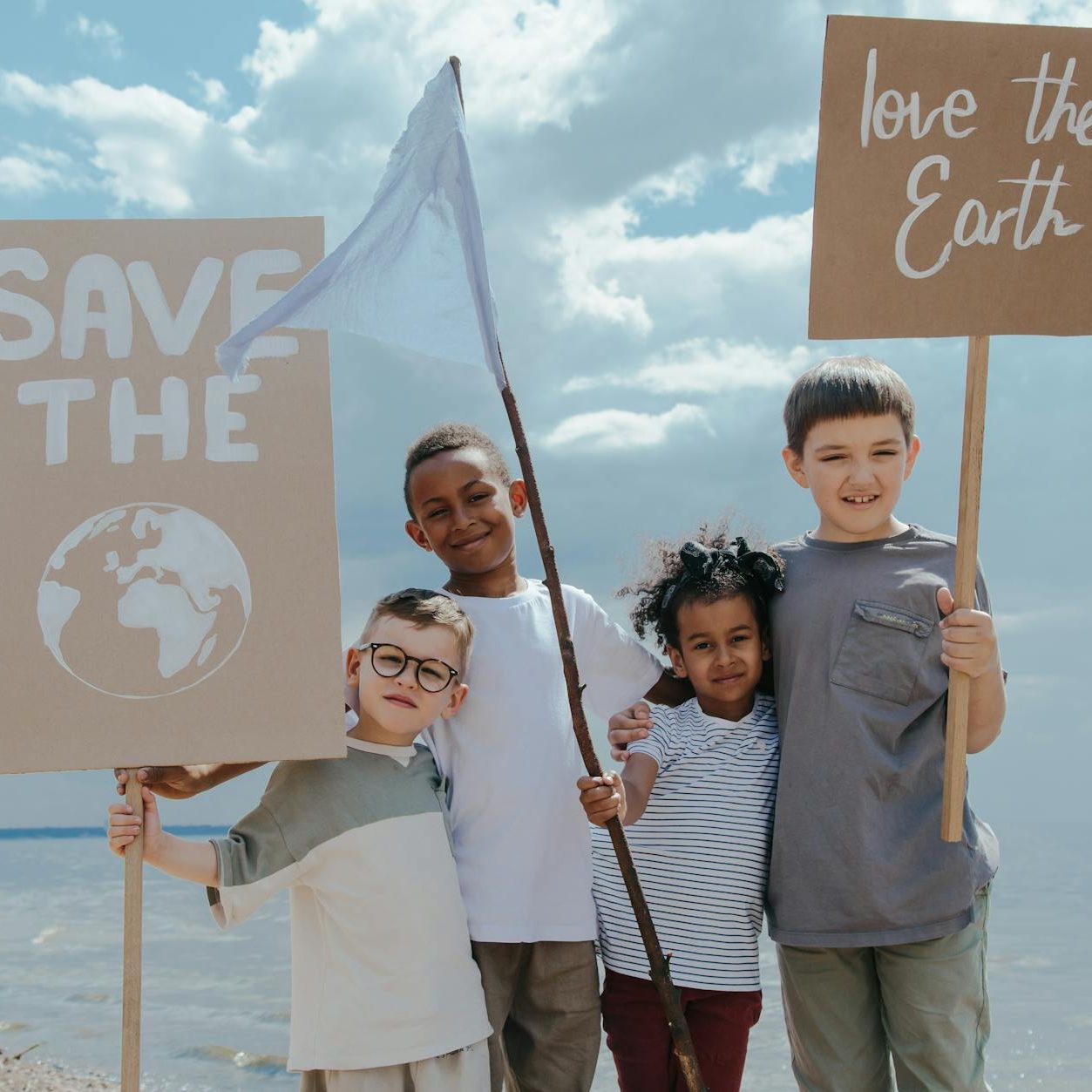 children standing together while holding signages